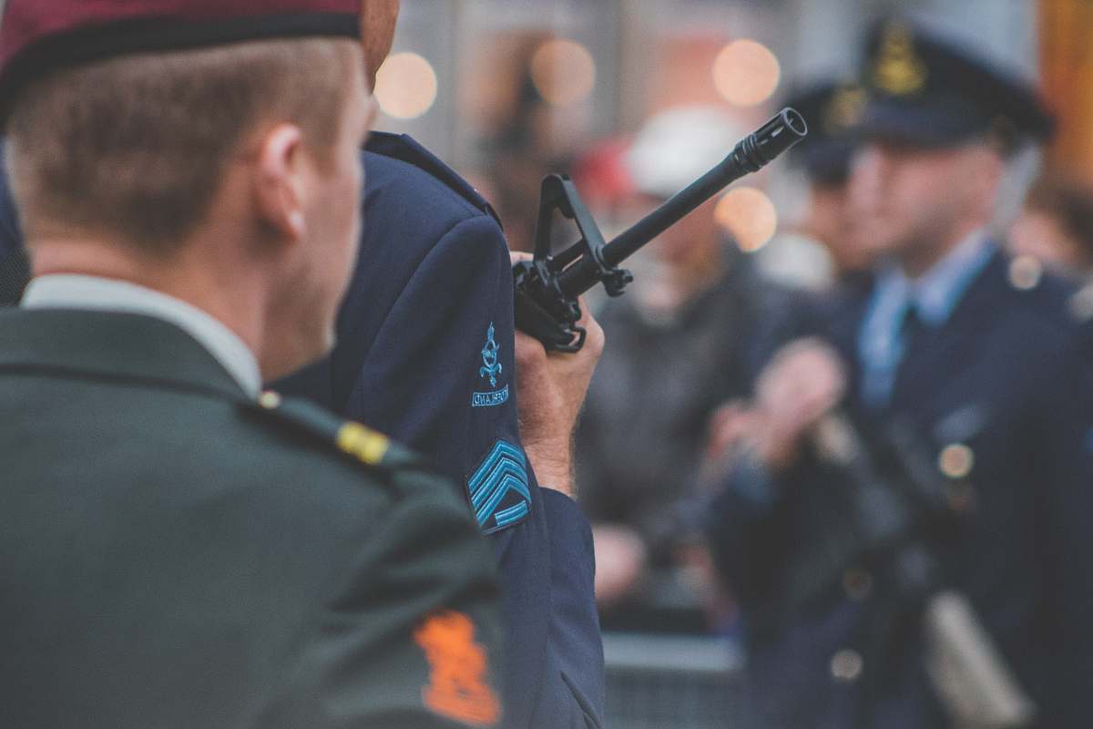 music shallow depth of field photo of man holding rifle musical instrument